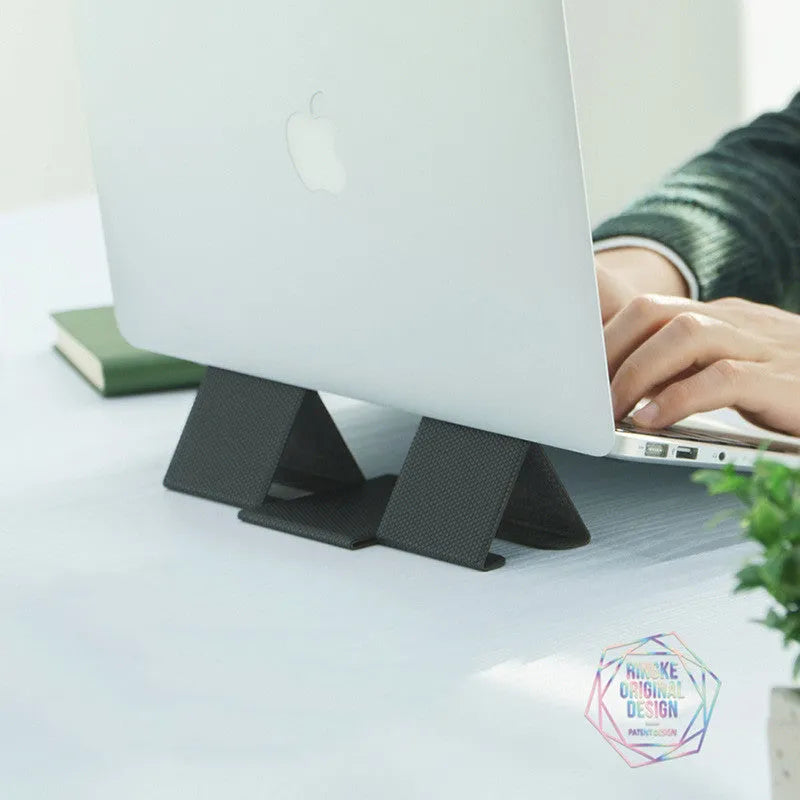 Ringke Folding Stand2 portable laptop stand in grey, folded open with a notebook placed on top