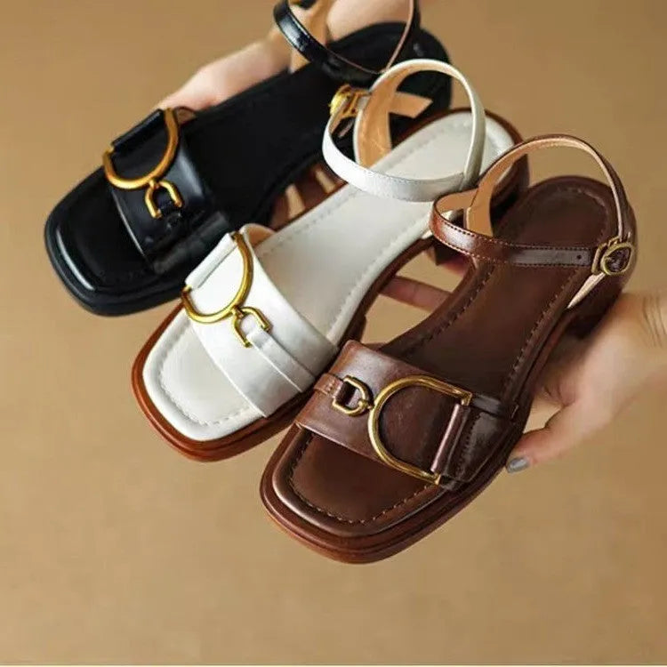 Women's brown leather sandals with a thick rubber sole and adjustable buckle strap.