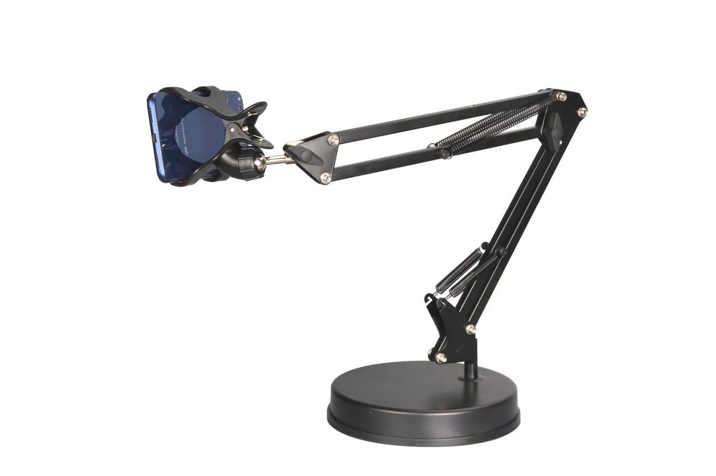Black universal phone stand with long metal arm and circular base on a wooden desk