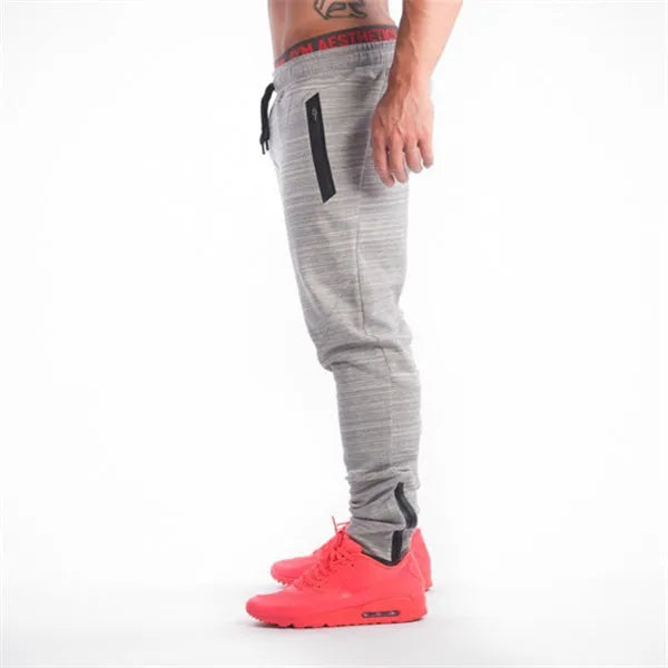 Men's slim-fit cotton sweatpants in grey black with elastic waistband and tapered leg