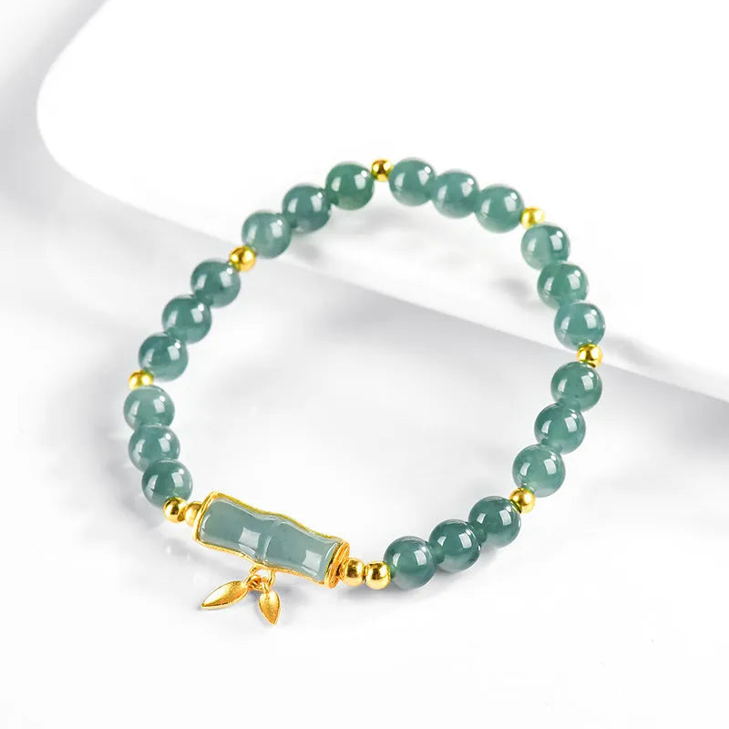 Women's silver bracelet with blue jade beads on a white background.