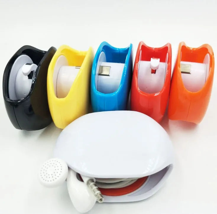 Compact automatic earphone winder in multiple colours on a grey background, showing extended cable.