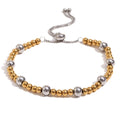 Gold geometric women's jewellery set with earrings, bracelet, and necklace on a plain background
