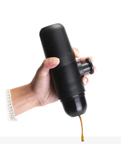 Black portable manual espresso machine showing 6cm diameter and 17.5cm height with stainless steel and plastic components.