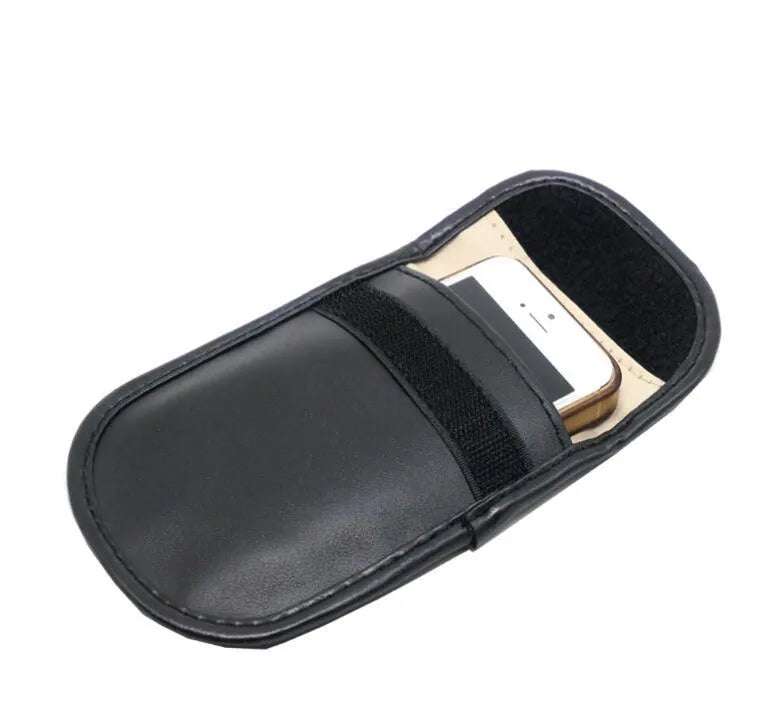Black plain microfiber faraday cage bag for blocking RFID and phone signals, shown with a key fob inside.