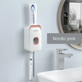 Blue automatic toothpaste dispenser mounted on a bathroom wall with motion sensor.
