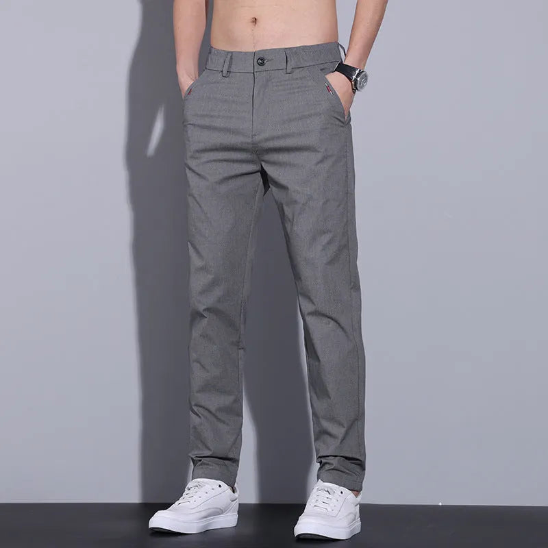 Men's straight-leg light khaki cotton trousers with a slim fit, laid flat to show the cut and micro-elastic fabric.
