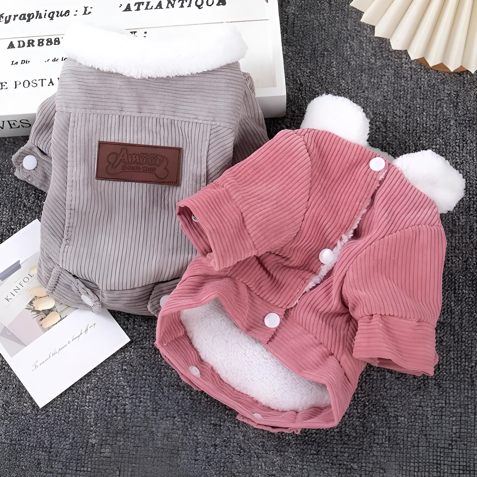 A gray lambswool-lined vest for a dog, showing the padded fleece construction and vest style.