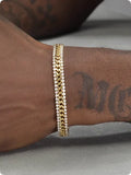 Gold hip hop style unisex tennis bracelet made from titanium steel with gemstone inlays.
