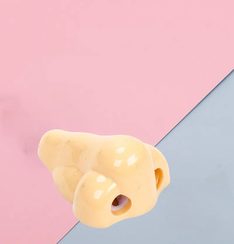 Flesh colour plastic big nostril manual pencil sharpener with geometric shape.