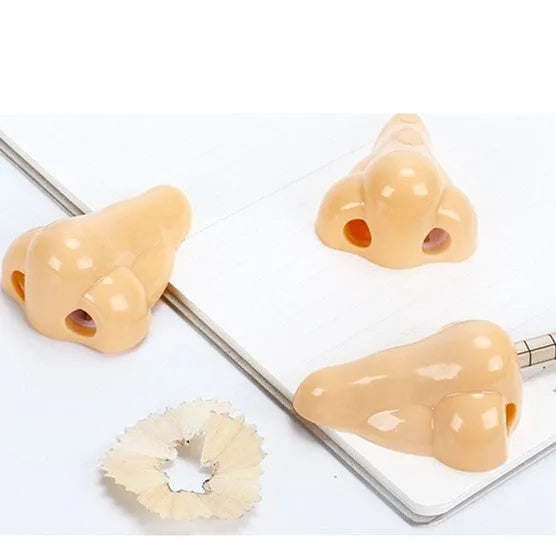 Flesh colour plastic big nostril manual pencil sharpener with geometric shape.