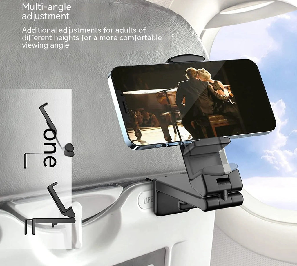 Foldable rotating universal phone holder in black on a desk next to a mobile phone.