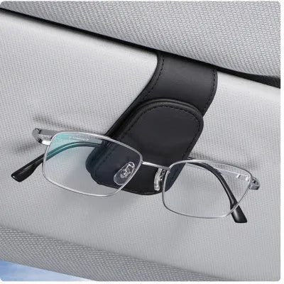 PU leather car sunglasses clip holder mounted on a grey sun visor.