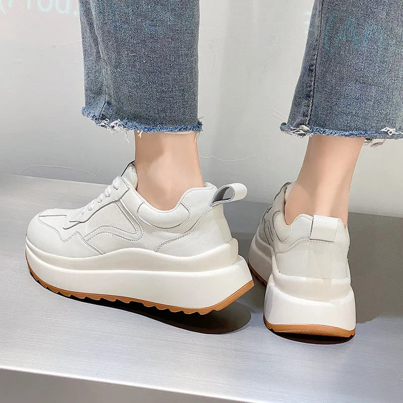 Women's beige low-top casual leather sports shoes with lace-up front and cross-strap detail on a white background