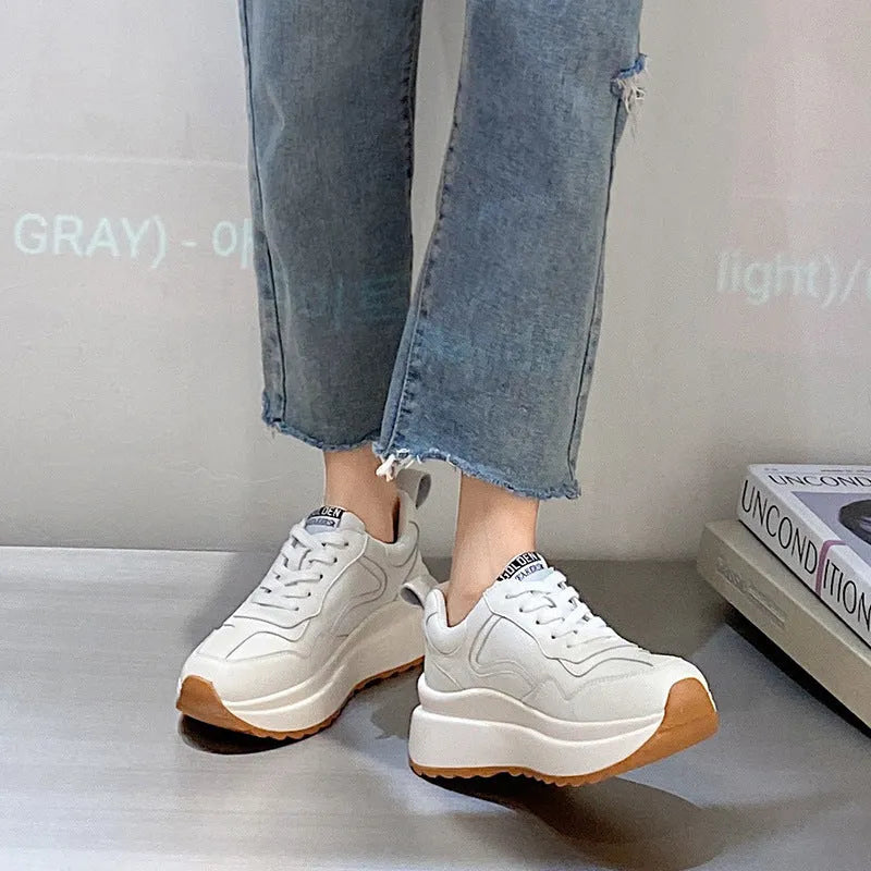 Women's beige low-top casual leather sports shoes with lace-up front and cross-strap detail on a white background
