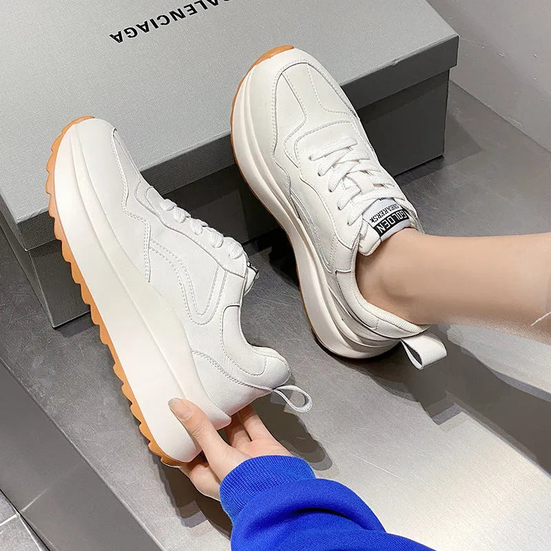Women's beige low-top casual leather sports shoes with lace-up front and cross-strap detail on a white background
