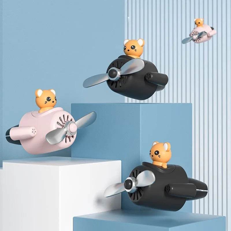 Cartoon aeroplane-shaped plastic car air vent aromatherapy diffuser with fragrant inserts.