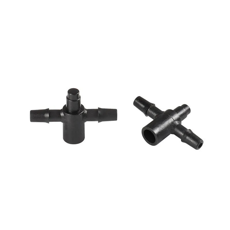 A white plastic tee water distributor joint for micro spray irrigation systems.