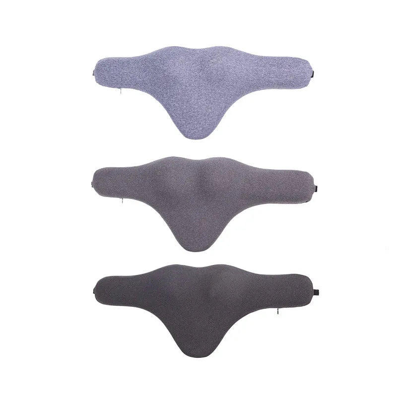 Dark grey memory foam car neck pillow resting on a car seat headrest.