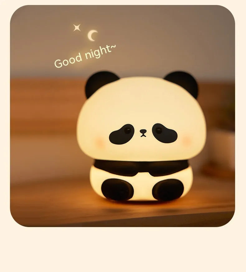 Cute panda LED night light with soft silicone cover, USB rechargeable, featuring colourful lighting modes on a bedside table.