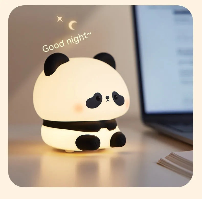 Cute panda LED night light with soft silicone cover, USB rechargeable, featuring colourful lighting modes on a bedside table.