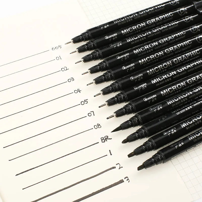 Set of black comic drawing pens with multiple nib sizes in a storage bag organiser.