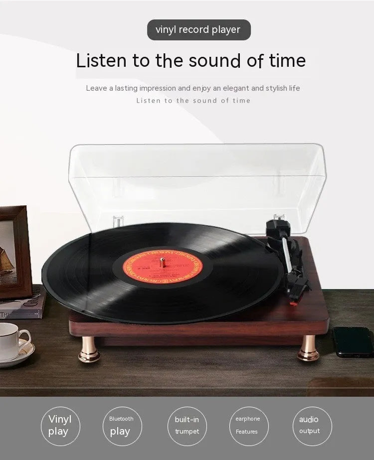 Retro vinyl record player with wood grain finish, transparent dust cover, and built-in speaker