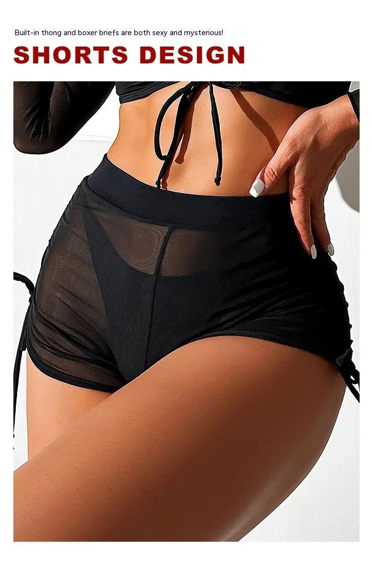 Black mesh four-piece women's bikini swimwear set with long sleeves on a hanger.
