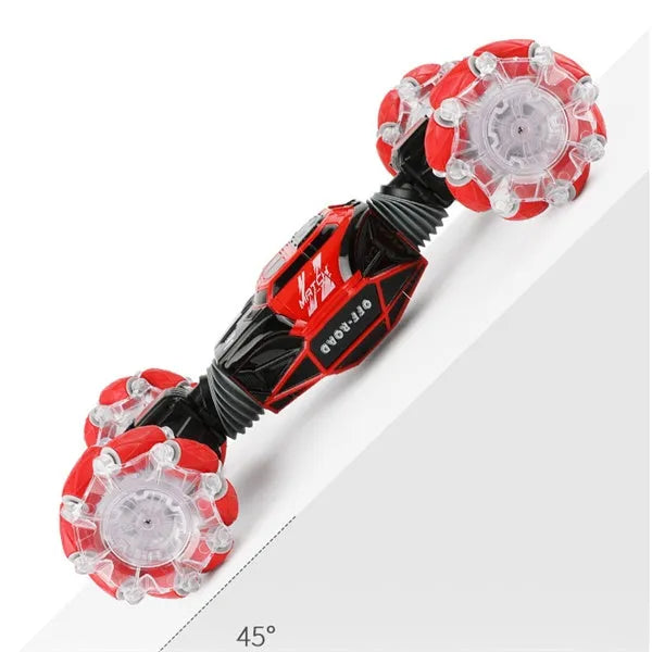 Red remote control stunt car with gesture control, morphing off-road tyres, lights, and music, measuring 32 cm long