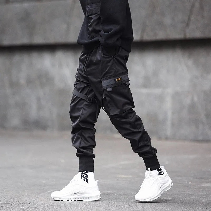Black 100% cotton overall trousers with tapered leg, front view, on a plain background.