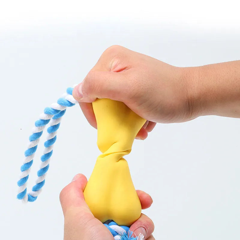 Green porous bone-shaped dog chew toy with rope knot texture on a white background.