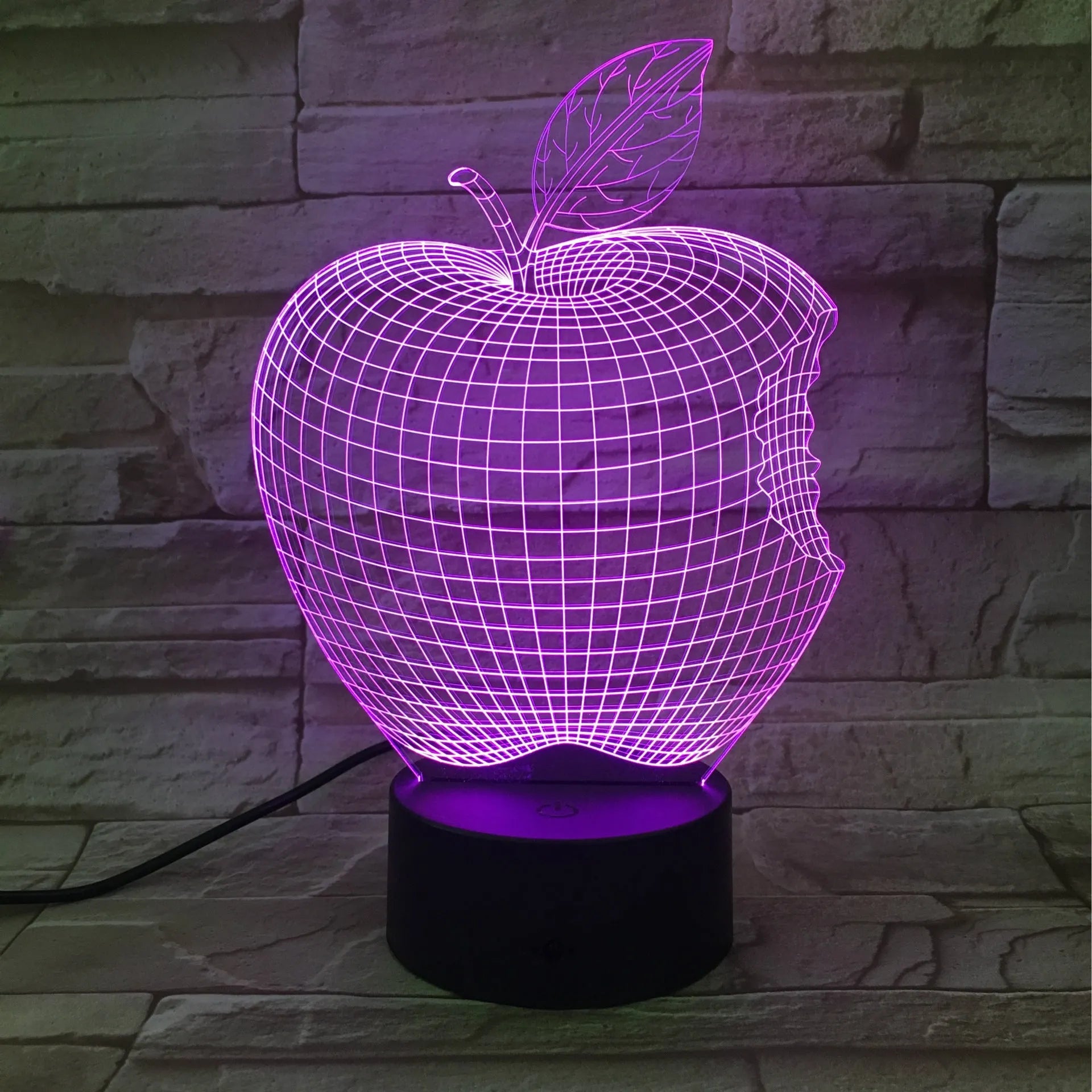 Colour-changing fruit-shaped acrylic night light with touch control on a surface.