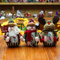 Set of red, green, and white flannel Christmas wall hangings showing snowman, elk, and old man designs.