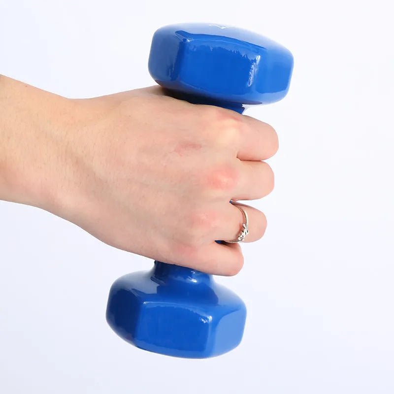 Set of bright coloured plastic fitness dumbbells showing 0.5kg, 1kg, and 1.5kg weights on a floor.