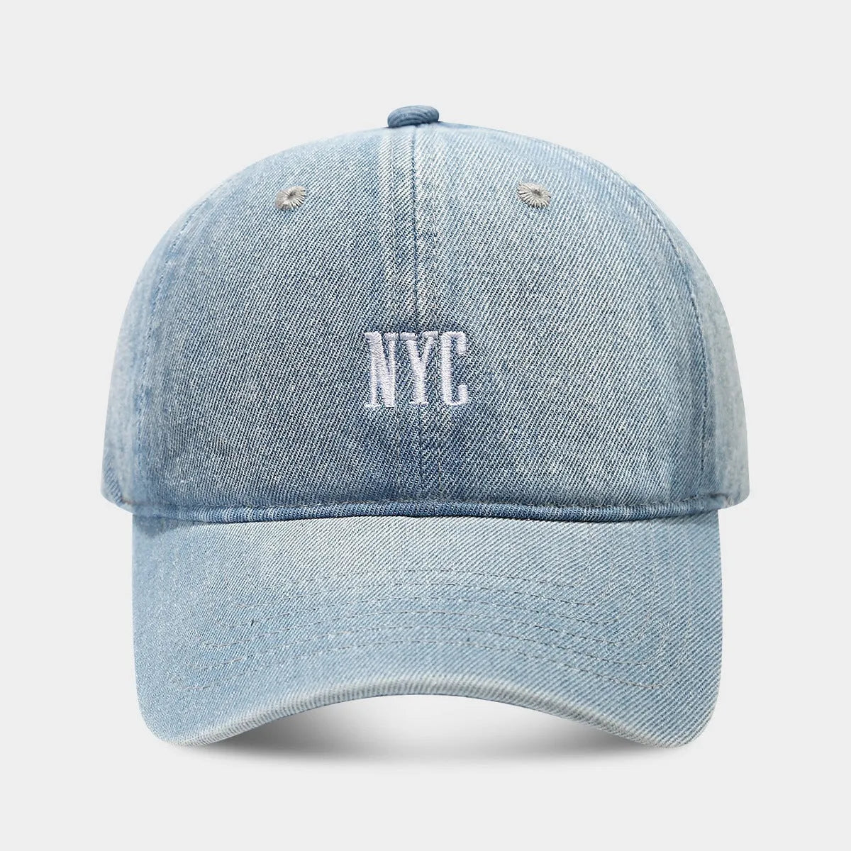 Adjustable denim peaked cap with embroidered lettering in light blue, dark blue, or black