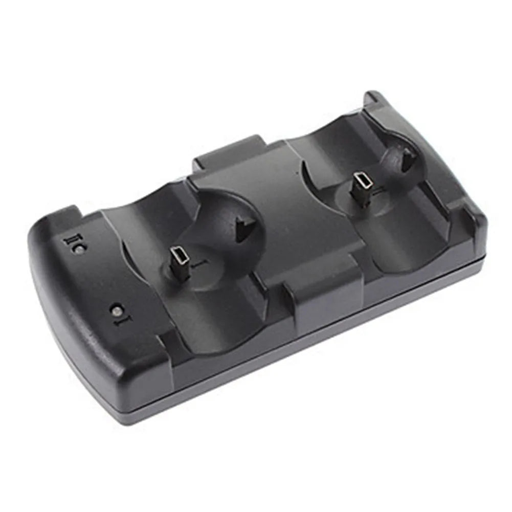 Black PS3 dual charging dock holding two wireless controllers, connected to a PlayStation 3 console with a single USB cable.