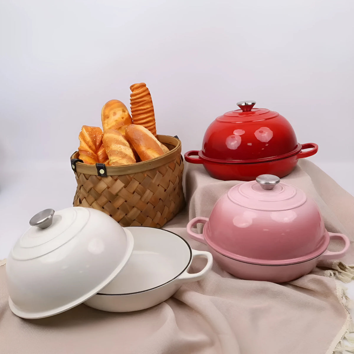 Cast iron enamel bread pot in black exterior, available in 24cm and 26cm sizes, with colour options blue, pink, red, white