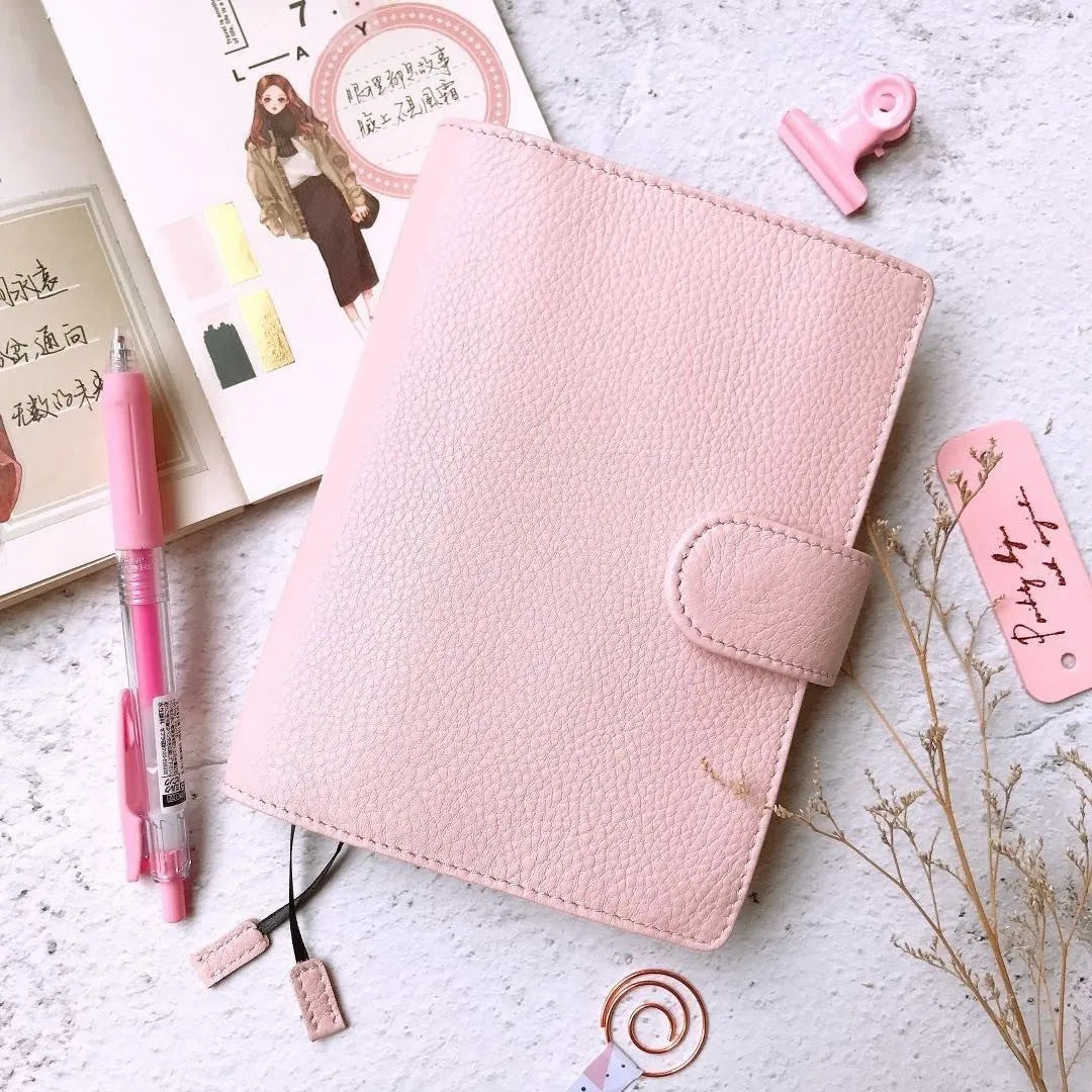 A6 leather notebook with lychee pattern cowhide cover showing loose-leaf binding in three colour options
