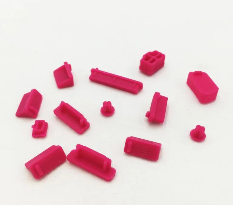 13-piece silicone dust plug set for laptop ports in multiple colours including transparent and black