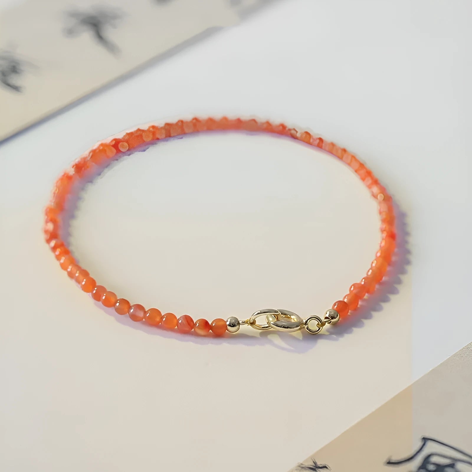 Women's Southern Red agate bracelet with 3mm cut surface in cherry red on a wrist.