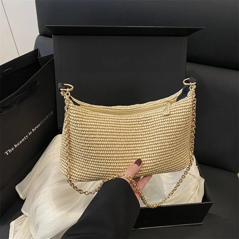 Woven straw beach shoulder tote bag in khaki colour with visible stitching and an outer pocket.