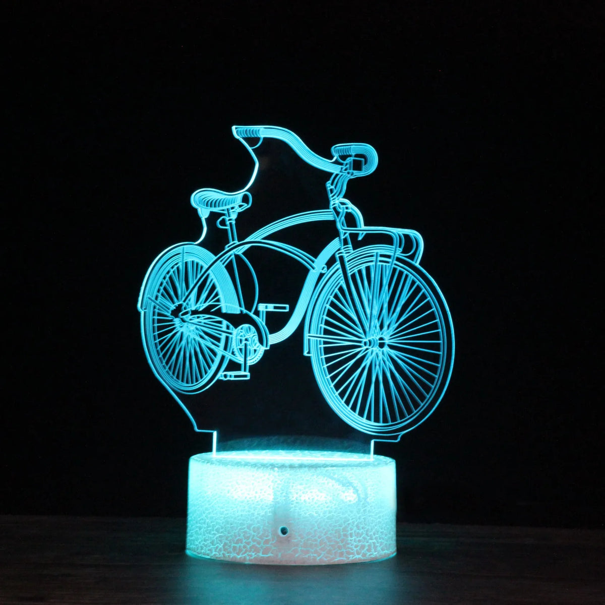 3D bicycle LED night light with acrylic shade and black base on a desk