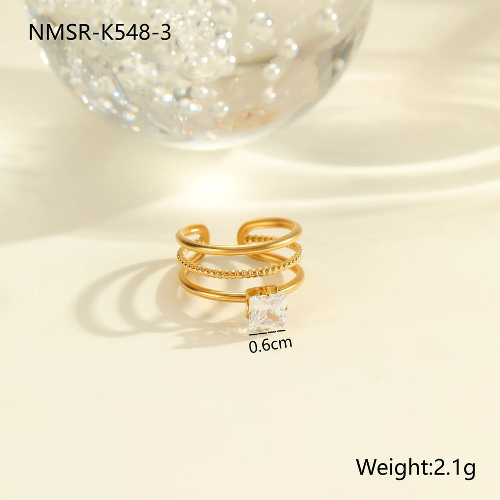 Gold colour stainless steel ring with zircon stones in a geometric heart drop shape design, open mouth.