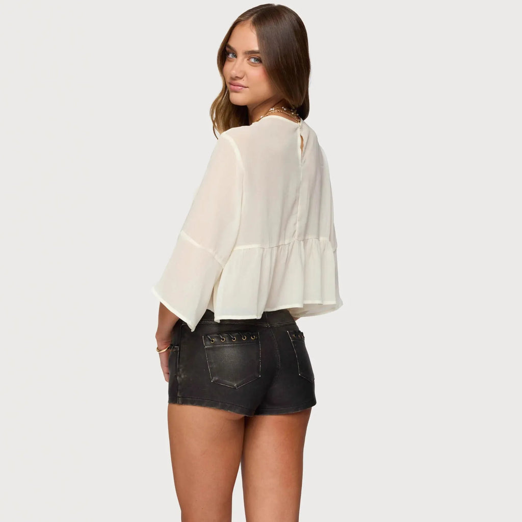 Creamy white women's chiffon top with batwing sleeves on a hanger.