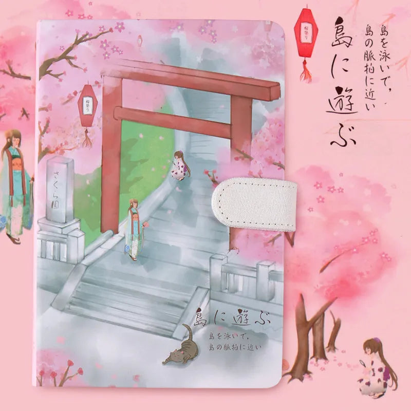 A5 wire-bound retro notebook open showing full-colour vintage illustrations, with a pen.