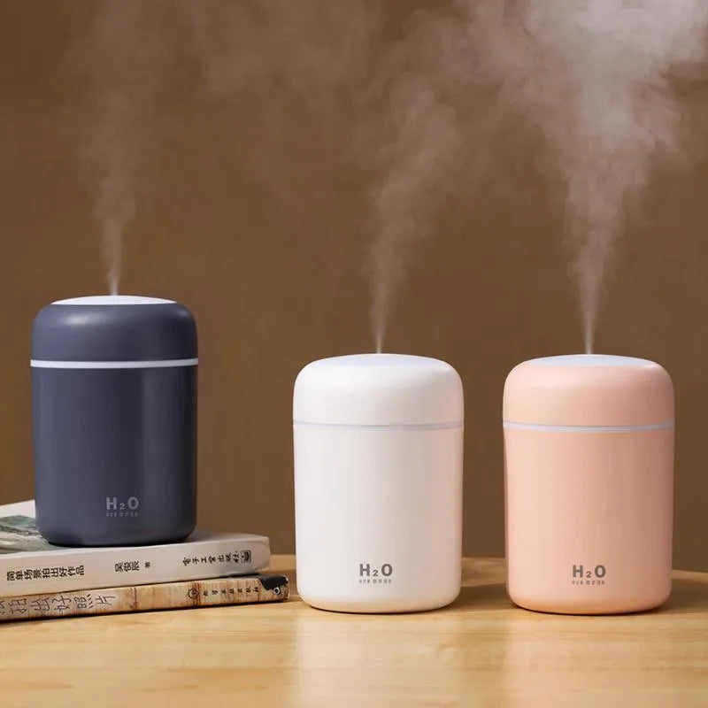 Pink USB desktop humidifier with colourful lights and water mist output