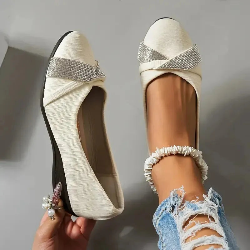 Women's black slip-on casual shoes with rhinestone decoration and a chunky heel.