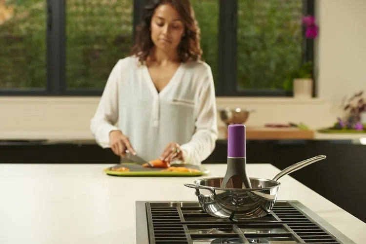 Green and grey automatic cooking mixer device for stirring sauces and soups.