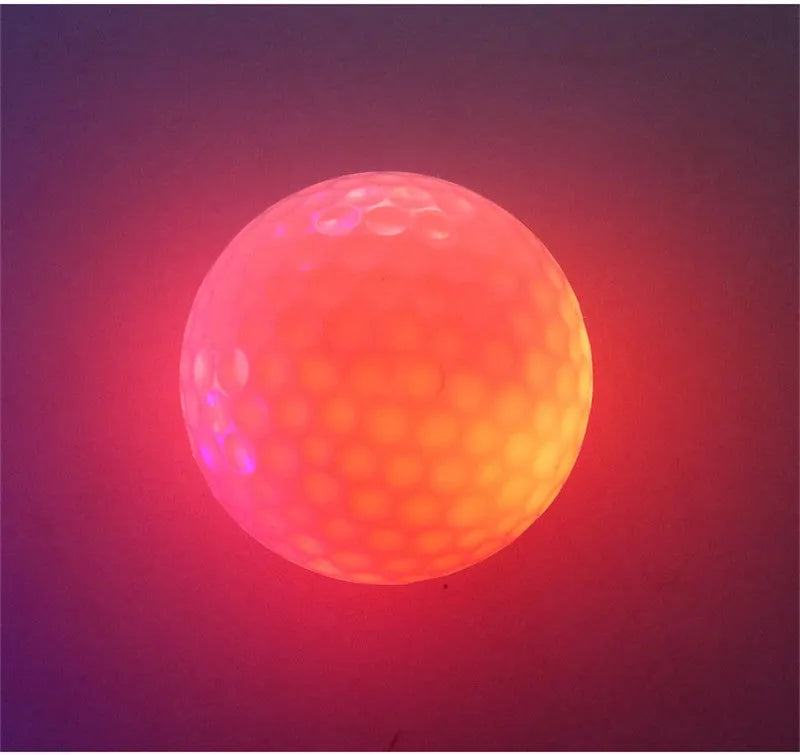 Glow Ball strobe golf ball on grass, random colour, 4.3 cm diameter