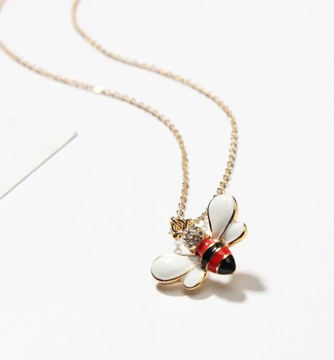 Cartoon bee drop pendant necklace with oil studded alloy finish on cross chain, yellow colour option, on white background